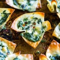 spinach and cheese wonton cups on a baking sheet