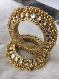 *This is Gold Finish Kundan Bangle Pair.Its Perfect for Wedding Occasion and is Unique and Ethnic Traditional Bangle to gift and also Bridal wear to match with Wedding Outfits. * Its made from Silver and Copper mix material and is 100% Handmade. * Its available in Various Sizes like 2,2.2,2.4,2.6 Etc.Its a combination of white kundan as shown in picture. *Its openable and Screwed Bangle Pair. *All Kundan stones set with silver foils handsetting method and long last guarantee of its workmanship.M Gold Bracelet Jewelry For Wedding, Ceremonial Toe Ring For Diwali, Gold Wedding Bracelet Jewelry, Gold Bangle Jewelry For Wedding, Kundan Bangle For Party, Kundan Toe Ring Jewelry For Weddings, Hand Set Gold Bollywood Bridal Accessories, Bollywood Style Gold Bridal Accessories With Hand Set Details, Wedding Meenakari Toe Ring Jewelry