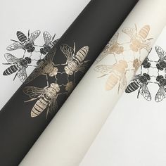 three different types of bees on black, white and gold wrapping paper with metallic foil