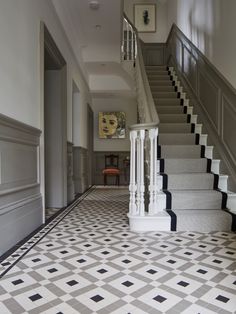 the stairs are lined with black and white tiles