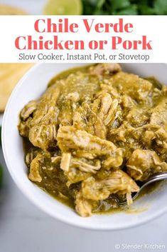 a white bowl filled with chicken and green salsa next to cilantro, tortilla chips