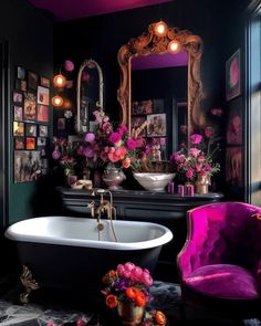 a bath tub sitting under a bathroom mirror next to a purple chair and table with flowers on it