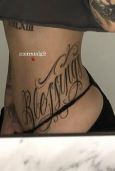 a woman with tattoos on her stomach and the words be strong written in cursive writing