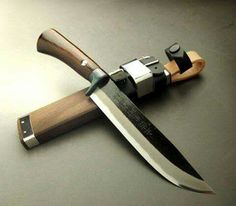 a large knife with a wooden handle on a table