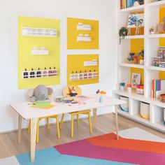 a child's playroom with toys and bookshelves