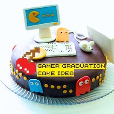 a cake that is decorated to look like an old computer game graduation cake with pacman characters on it