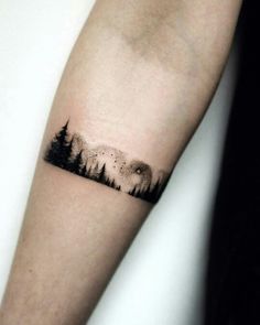 a forest tattoo on the arm