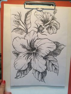 a drawing of flowers on a clipboard with a person's hand next to it