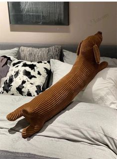 a large brown dog laying on top of a bed