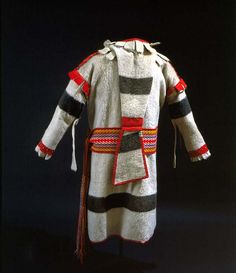 a white coat with red, black and grey stripes on the sleeves is displayed in front of a dark background