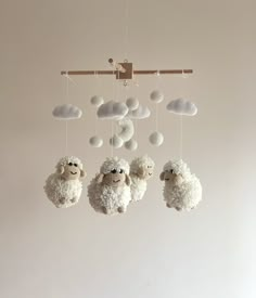 three white sheep hanging from the ceiling