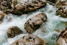 the water is rushing between some rocks