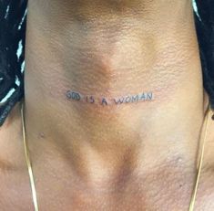 a woman's chest with the words god is a woman tattooed on her right side