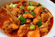 a white bowl filled with meat and vegetables