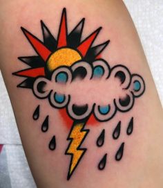 a tattoo with a lightning and clouds on it