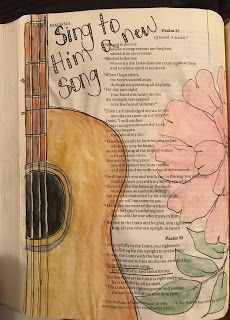 an open bible with a drawing of a guitar and flowers on the page in it