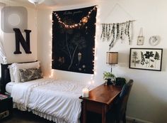 a small bedroom with string lights on the wall