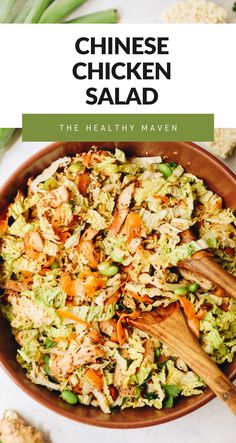 chicken salad in a bowl with wooden spoons and celery on the side