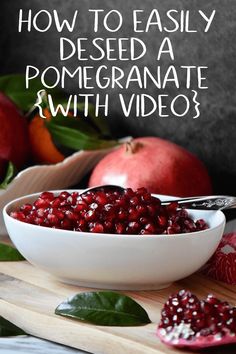 pomegranate in a white bowl on a cutting board with apples and leaves