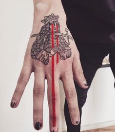 a person's hand with a red line painted on it and an arrow in the middle