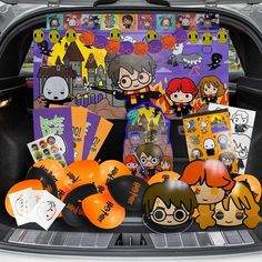 the trunk of a car is filled with halloween decorations