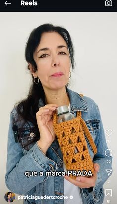 a woman is holding a crocheted can holder in her hand and looking at the camera