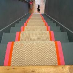 an escalator with carpeted steps leading up and down