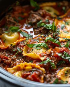 a pot filled with pasta and meat covered in sauce, parmesan cheese and herbs