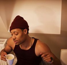 a man sitting at a table with a cup of coffee