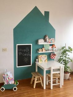 a child's playroom with a chalkboard on the wall