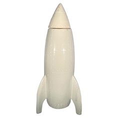 a white plastic toy rocket ship on a white background