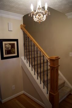 a chandelier hanging from the top of a stair case