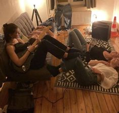 three people are sitting on the floor playing video games and having fun with each other