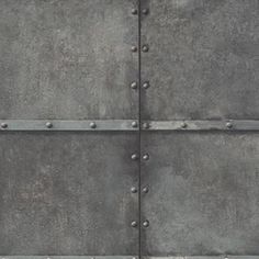 an old metal wall with rivets is shown in this image, it appears to be grungy