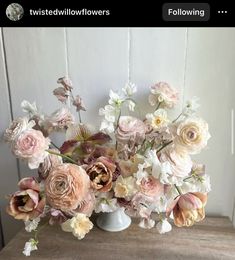 a vase filled with lots of pink and white flowers