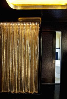 a gold curtain in front of a black door