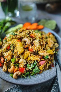 a plate filled with rice and vegetables on top of a table