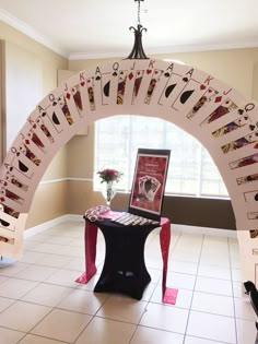 an arch decorated with playing cards in the shape of a heart and sitting on a table