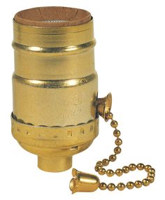 an old brass canister with a chain attached to it