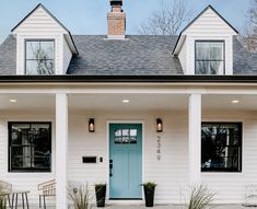 a white house with blue front door and windows