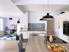 a kitchen with an island and table in it