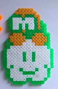 two pieces of perler bead art with carrots and broccoli on them