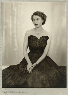 an old black and white photo of a woman in a dress