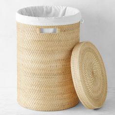 Strong yet lightweight, rattan baskets are ideal for stowing and carrying laundry. Ours are hand woven in a space-saving cylindrical shape with cutout handles for easy toting. Each one comes with a fitted lid and a machine-washable cotton liner.  Hand woven of rattan.  Finished with clear, protective lacquer.  Comes with fitted lid and machine-washable cotton liner.  A Williams Sonoma exclusive. #laundryroomstorage Rattan Laundry Basket, Rattan Baskets, Storage Organizers, Kids Pottery, Laundry Baskets, Fabric Shaver, Rattan Basket, Pottery Barn Teen, Custom Upholstery