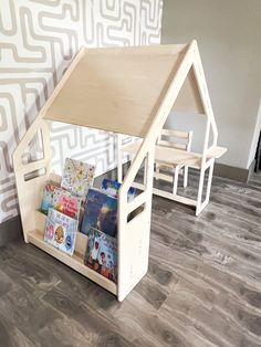 a wooden doll house with books in it