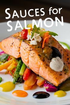 salmon on a white plate with sauces for salmon and colorful vegetables in the background