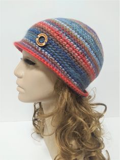 Stylish, retro woman hat, a colorful, fancy hat made of wool, style bucket hat. Very warm and cozy, becasue it's made of wool and acrylic. The majority of wool (60%) in the yarn gives You warmth and softness, the acrylic (40%) prevents from itchiness and makes the item durable. The hat is very comfortable in many ways - soft, fancy, warm, and You can put it in Your bag when it's necessary and it won't rumple or loose it's shape.  The hat in the foto fits a standard woman's head circumference 54-56 cm, it's rather an M-size, it's about 22cm high with the brim. Please let me know if You wish Your hat in other size. I will be happy to crochet it for You :-) Hand wash using a detergent for woolen clothes, do not use any bleach, or fabric softeners. Remember to dry your hat flat and don't let i Multicolor Brimmed Cloche Hat, Multicolor Curved Brim Cloche Hat For Winter, Multicolor Winter Cloche Hat With Short Brim, Multicolor Winter Cloche Hat With Curved Brim, Handmade Yarn Cloche Hat, Retro Crochet Yarn Hat, Retro Yarn Beanie Hat, Vintage Yarn Beanie Hat, Retro Handmade Crochet Hat For Winter