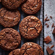 chocolate cookies on a cooling rack with pieces of chocolate in the background