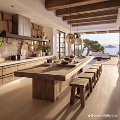 a large kitchen with an island and wooden table in the center, along with chairs