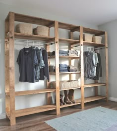 a wooden shelf with clothes hanging on it